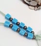 White Glass Pendant with Gold and Blue Cosmic Swirls on a Beaded Necklace - Image 3
