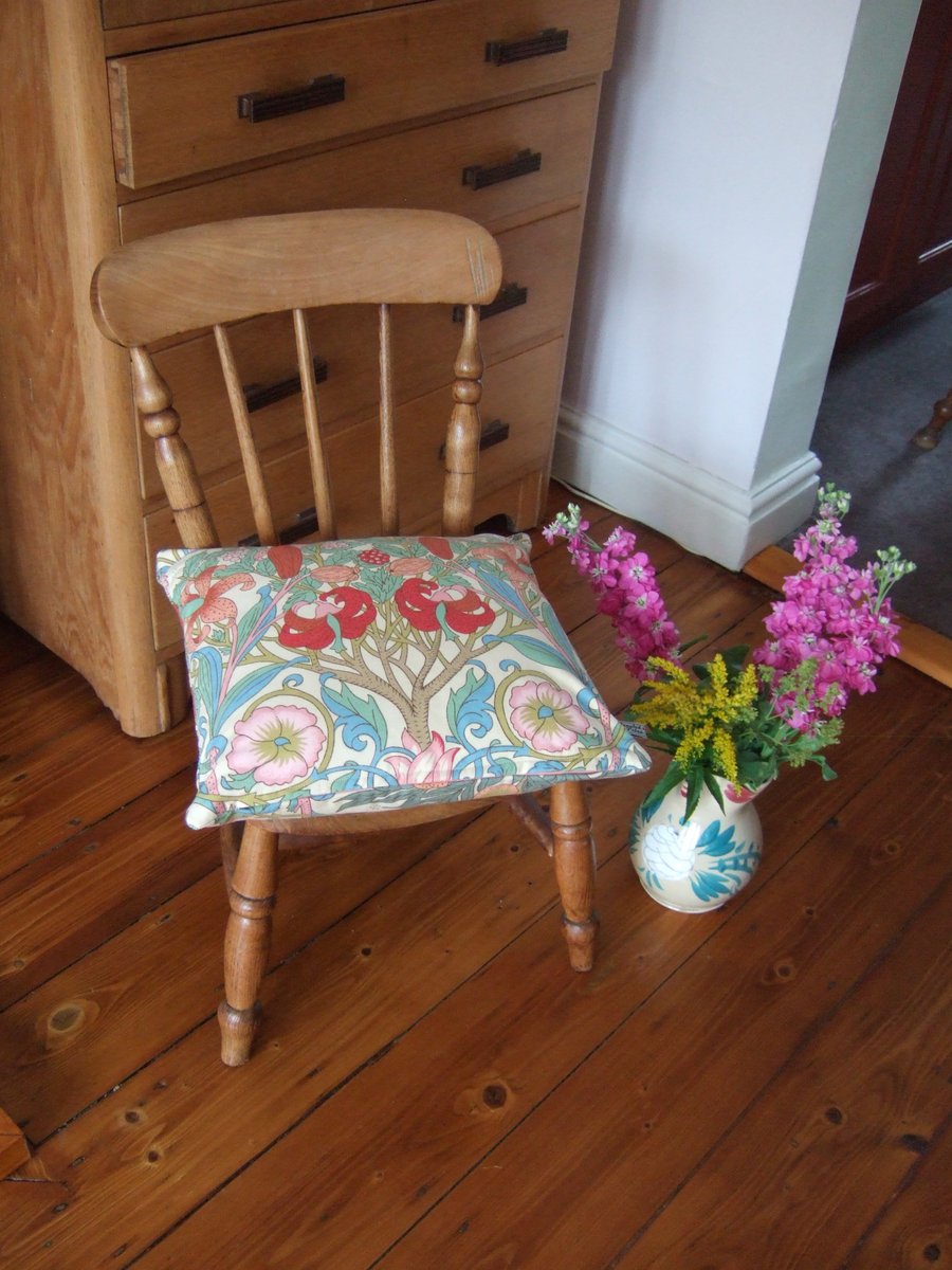 Vintage Liberty floral fabric cushion with feather pad.