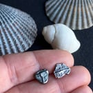 Mismatch pair of recycled oxidised silver stud earrings.