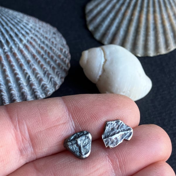 Mismatch pair of recycled oxidised silver stud earrings.