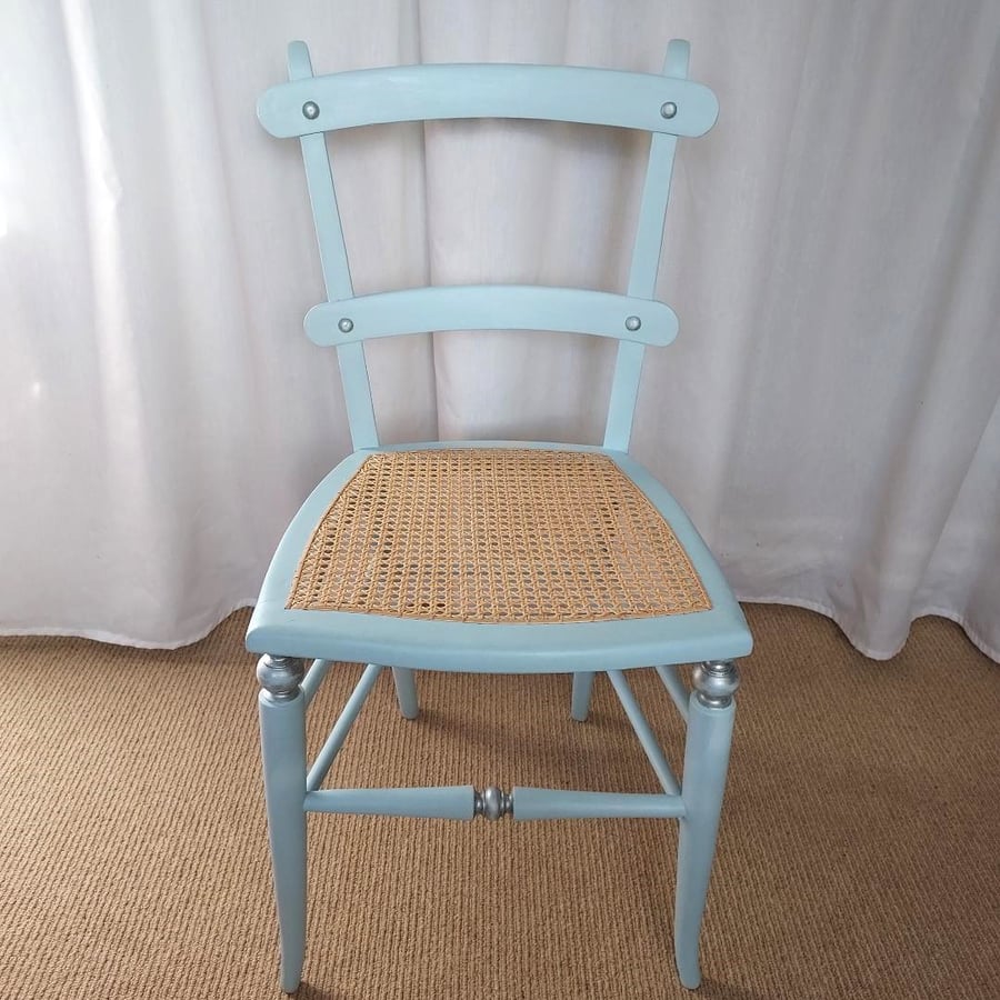 Upcycled antique chair in pale blue chalk paint, re-caned seat.