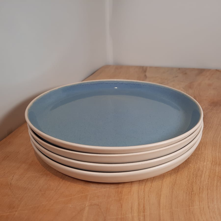 TWO 7.5INCH PLATES. BLUE AND WHITE HAND MADE POTTERY