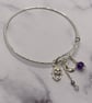 Silver plated charm bangle with clear topaz and amethyst stones 