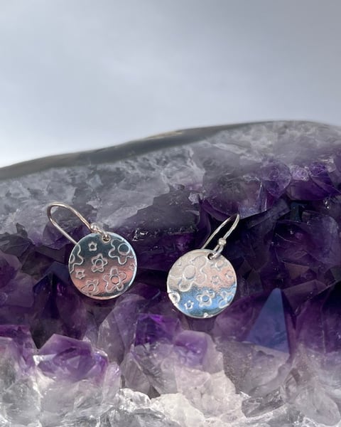 Silver round earrings with flower texture