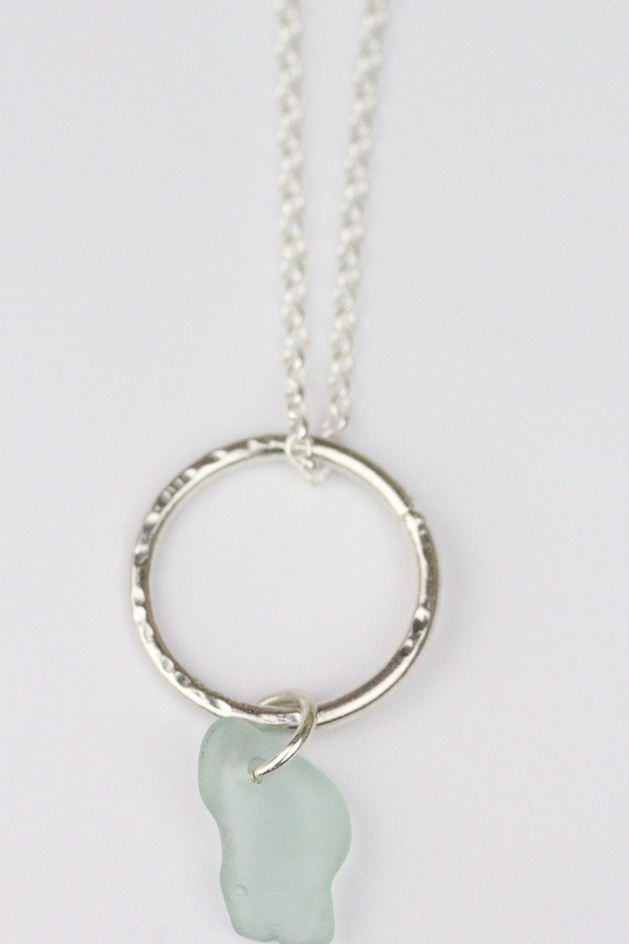 Silver hammered circle necklace with turquoise sea glass