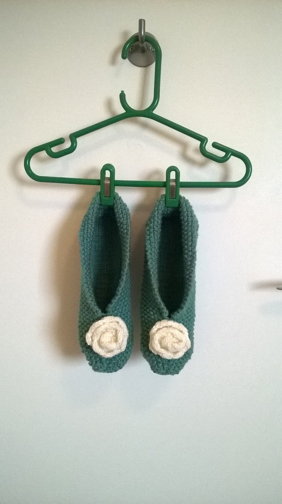 Handmade knitted slippers with a rose