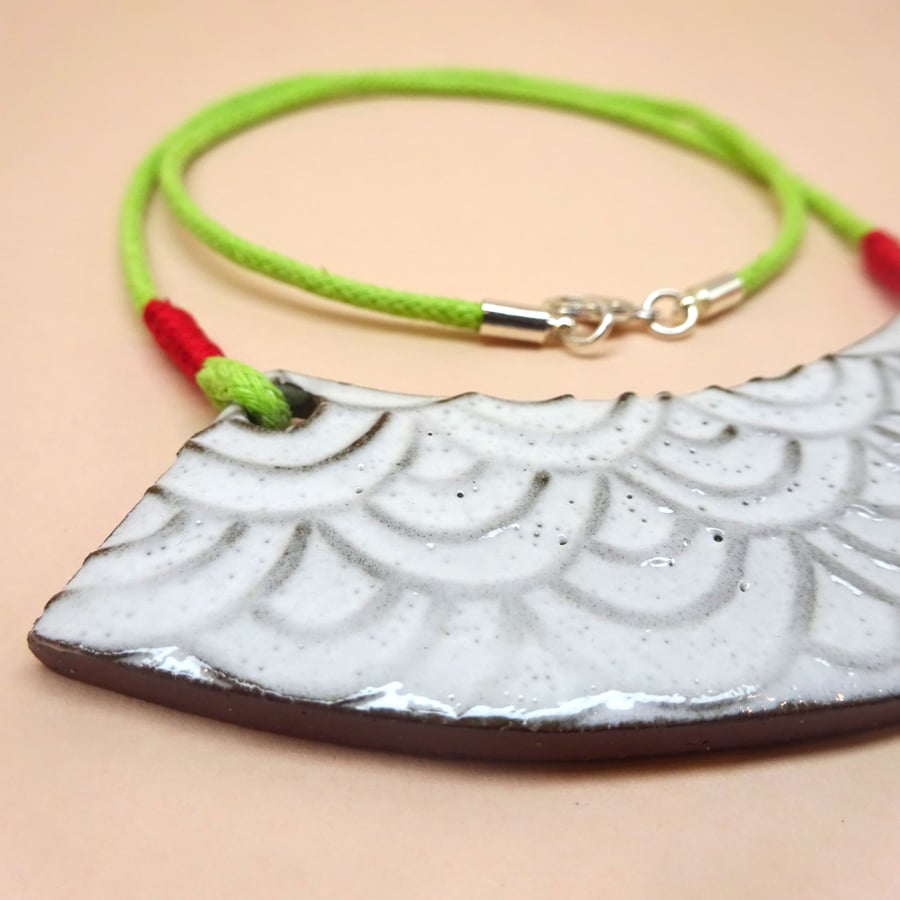 Geometric ceramic necklace on a lime green and red cord