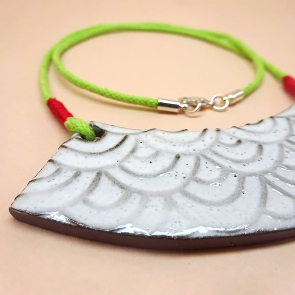 Geometric ceramic necklace on a lime green and red cord