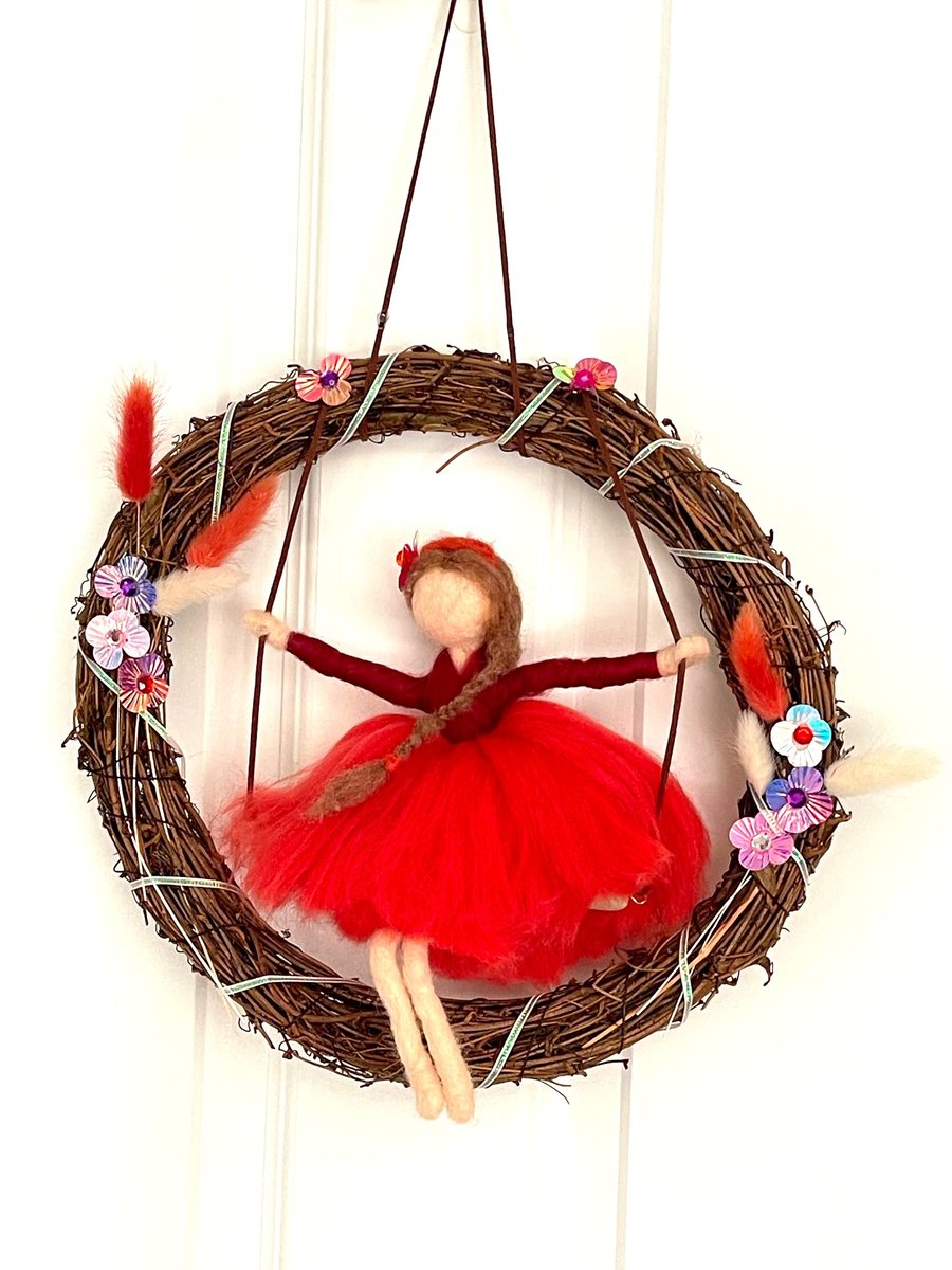 Scarlett  on swing with wreath
