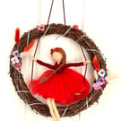 Scarlett  on swing with wreath