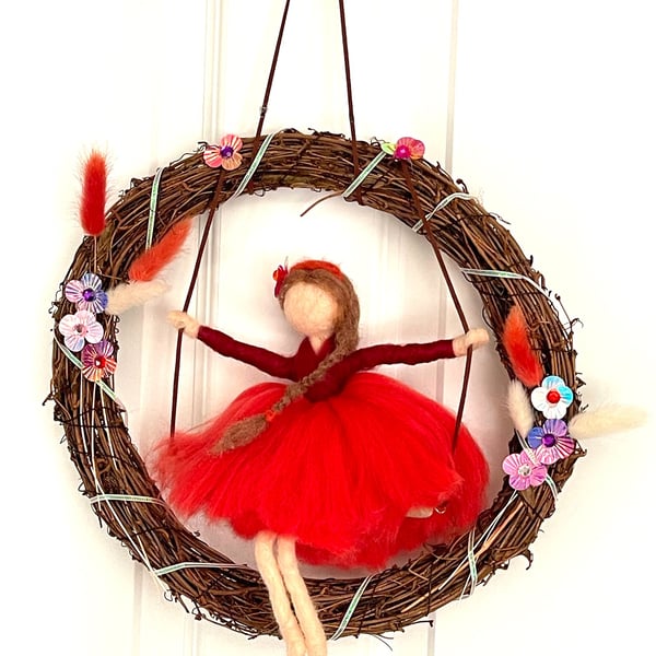 Scarlett  on swing with wreath
