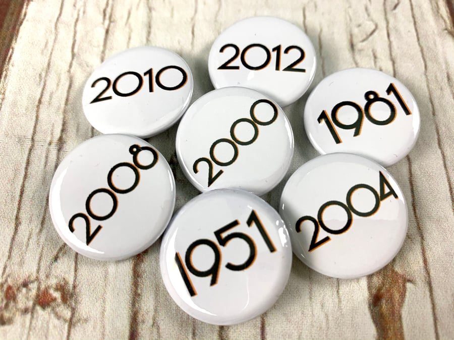 Birthday year badges black letters 'Branson' font. Sizes: 25mm, 38mm Pin