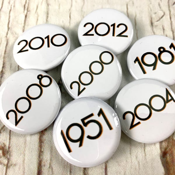 Birthday year badges black letters 'Branson' font. Sizes: 25mm, 38mm Pin