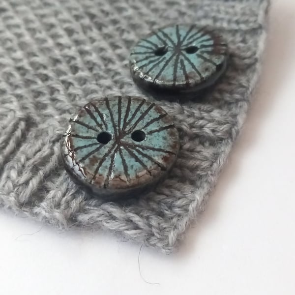 A set of 3 25mm buttons, Black and blue buttons. Inspired by mill stones. 