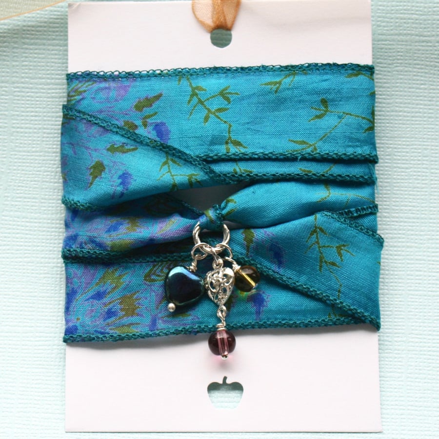 Blue green patterned silk ribbon wrap bracelet with heart and glass charms