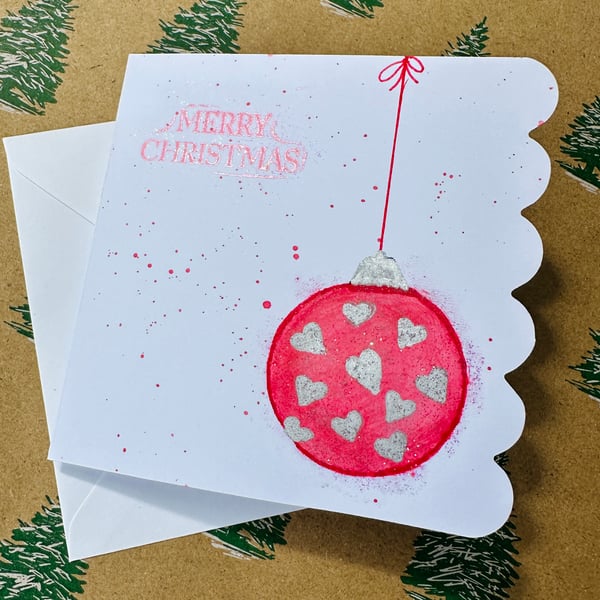 Contemporary Christmas watercolour art card with red bauble and silver hearts 