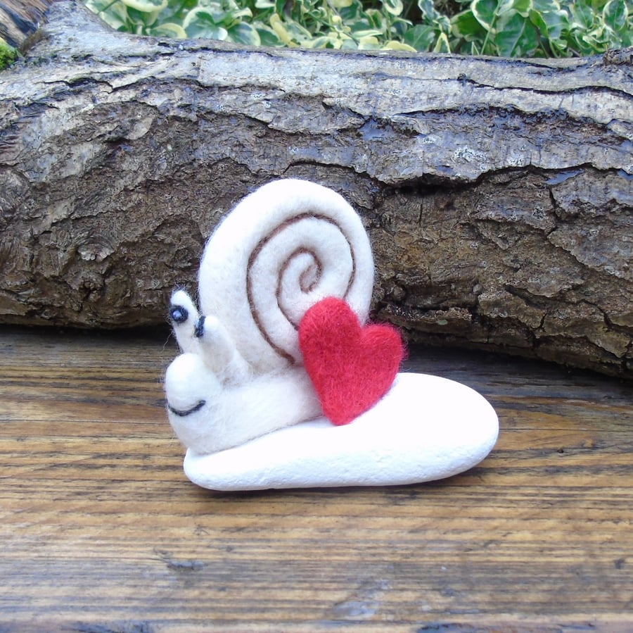 Felted snail white stone.  Needle felting, with pocket hug heart