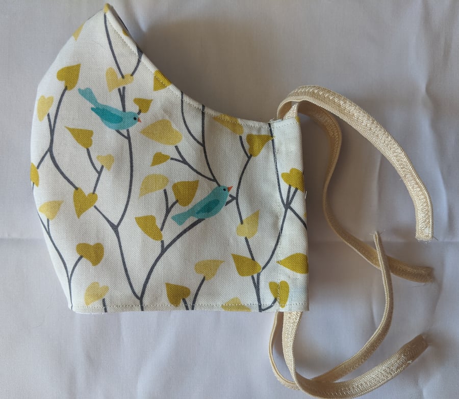 Cotton face mask with bird and leaf pattern