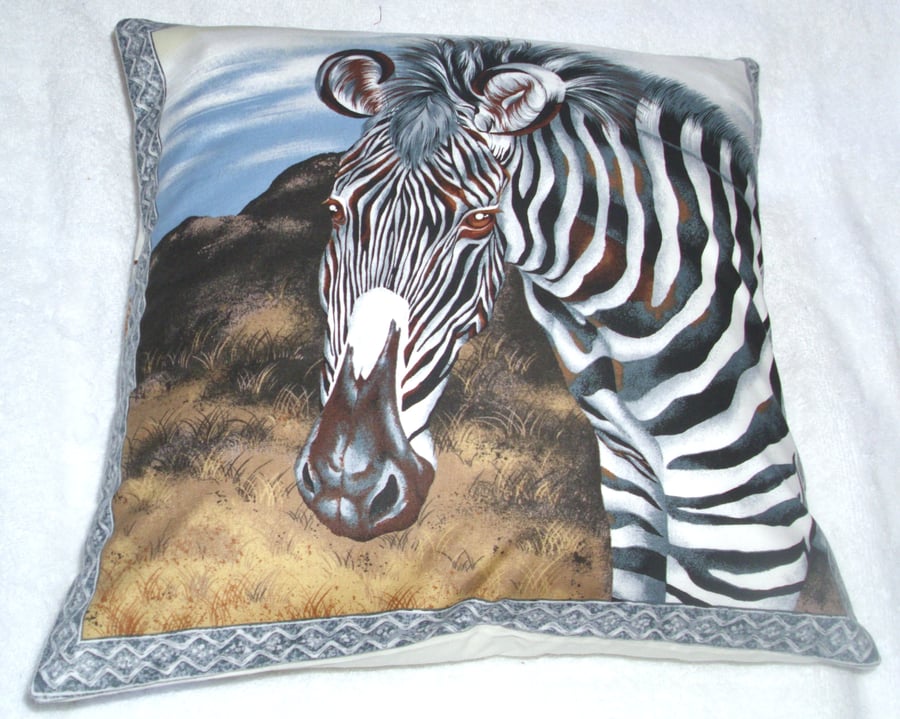 On Safari cushion with a Zebra on a grass plain