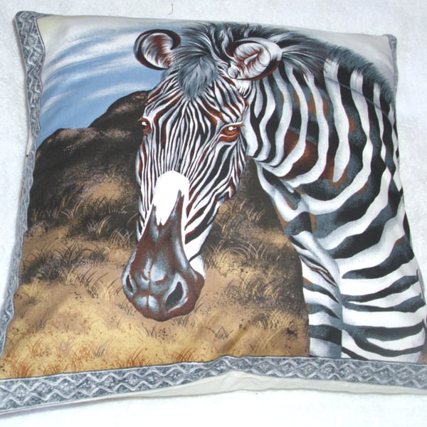 On Safari cushion with a Zebra on a grass plain