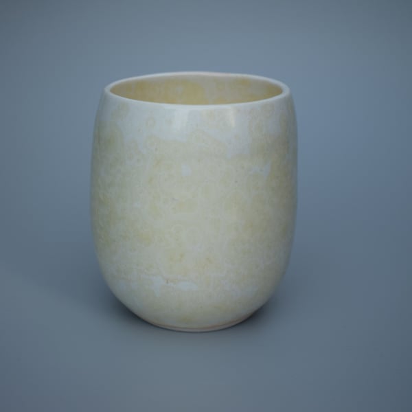 Stoneware teacup, tumbler or beaker in pale yellow with a hint of orange 