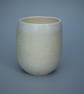 Stoneware teacup, tumbler or beaker in pale yellow with a hint of orange 