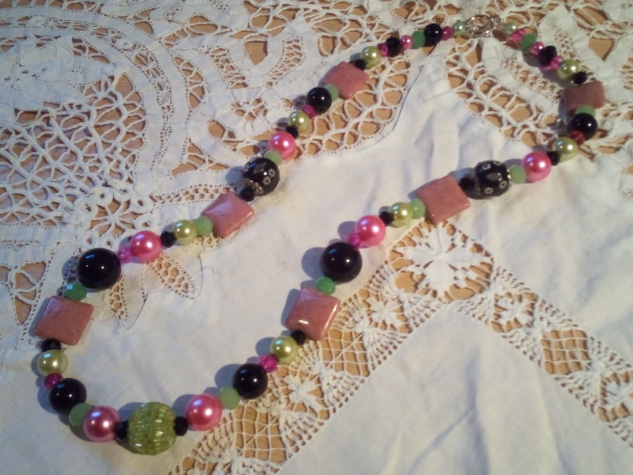 Hypnotic necklace with mixed green , pink and black glass clay and resin beads