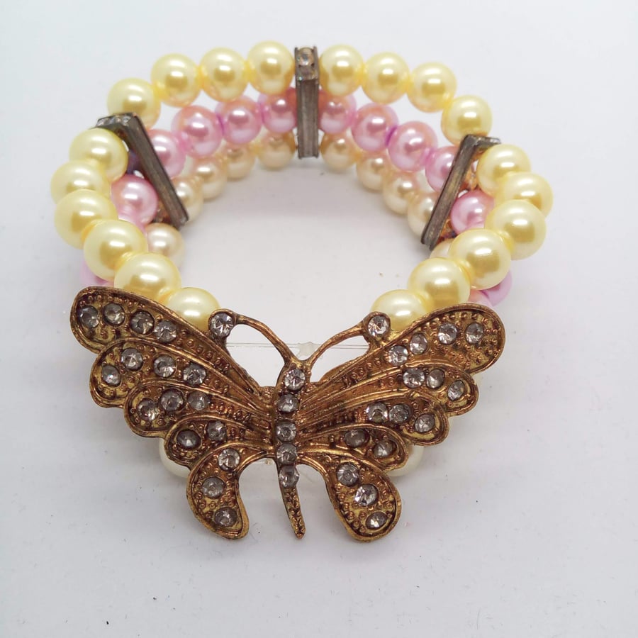 3 Strand Pearl Bracelet With A Gold Plated Rhinestone Butterfly Centrepiece