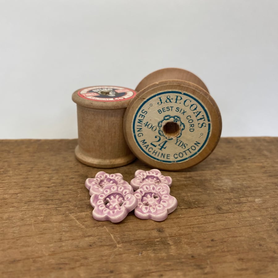 Set of four little handmade ceramic flower buttons pink