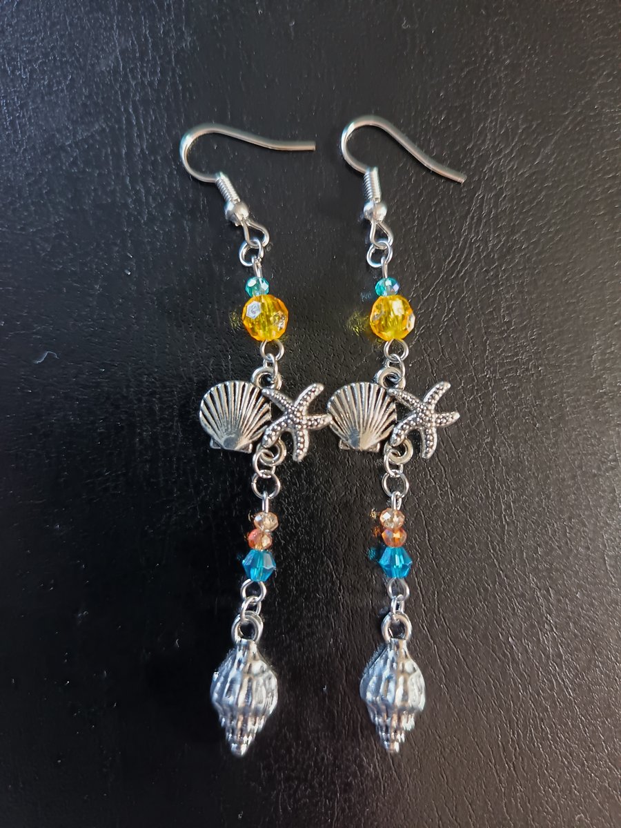 Silver beaded dangle earrings with shell charms 