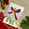 Card, Christmas card, bunch of mistletoe tied with red ribbon.