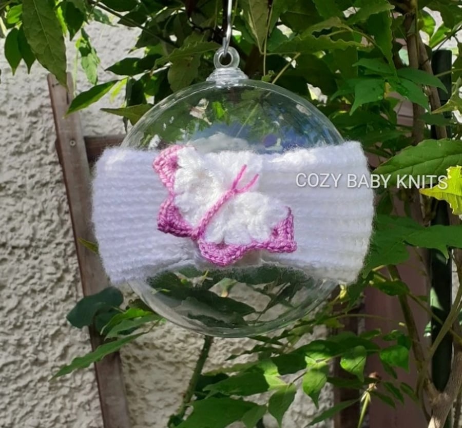 ARAN BABY EARWARMER WITH A BUTTERFLY APPLIQUED ON IT