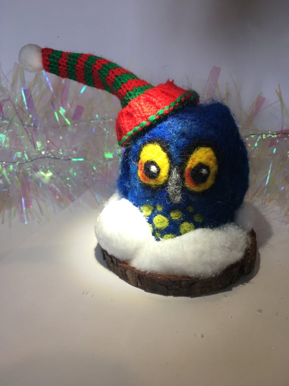 A needle felted owl in the snow