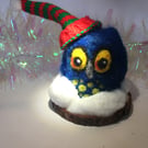 A needle felted owl in the snow