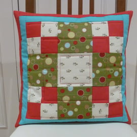Red and green square patchwork cushion