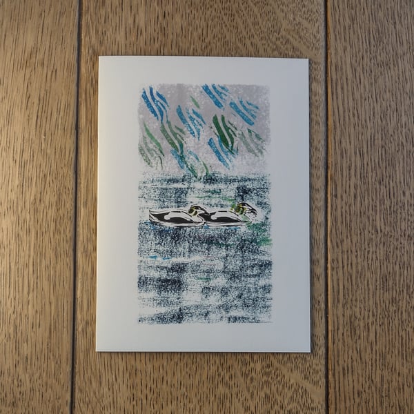 Two Eiders swimming, original design made using hand-cut stamps.