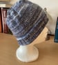 WOMENS HAND KNITTED HAT IN MULTICOLOURED BLUE YARN APPROX 9" or 23cm LONG