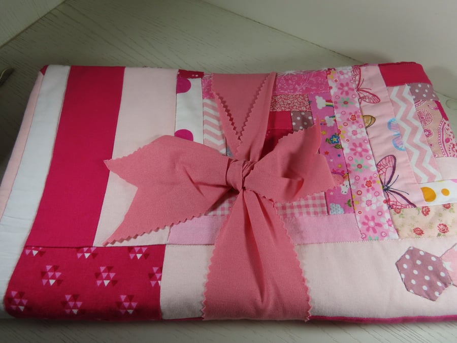 Handmade, quilted cot blanket for the nursery in Bright Pink.