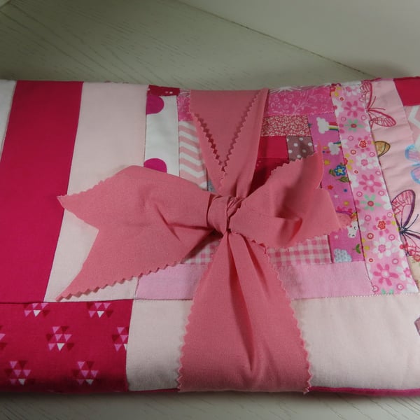 Handmade, quilted cot blanket for the nursery in Bright Pink.