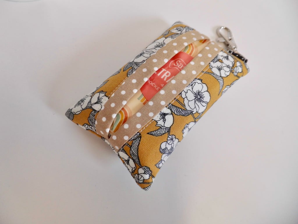 Key ring tissue tidy in mustard and black floral fabric with a useful clasp