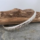 Solid silver bangle with a unique bubbles all overpattern 