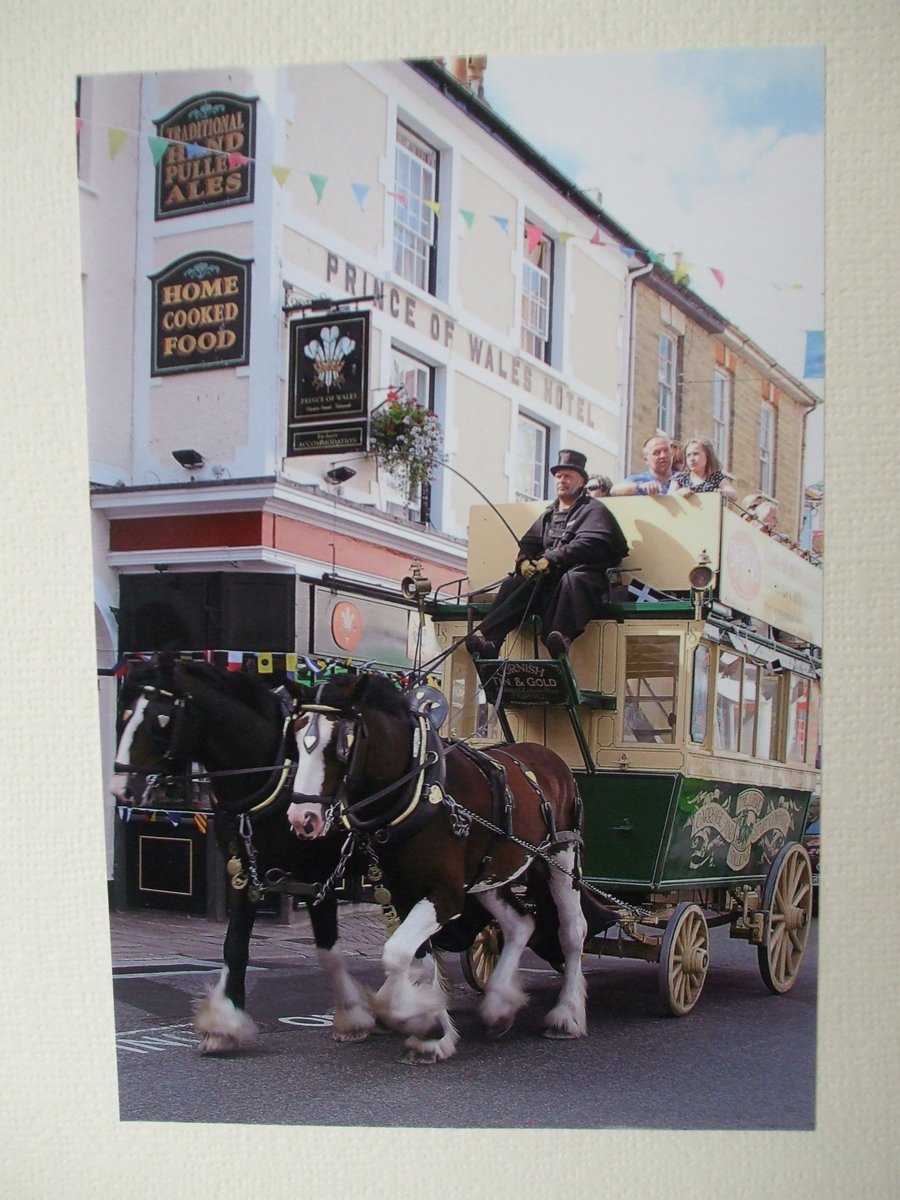 Photographic greetings card of a Horse Drawn Bus outside a hotel.