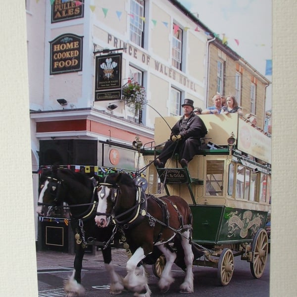 Photographic greetings card of a Horse Drawn Bus outside a hotel.