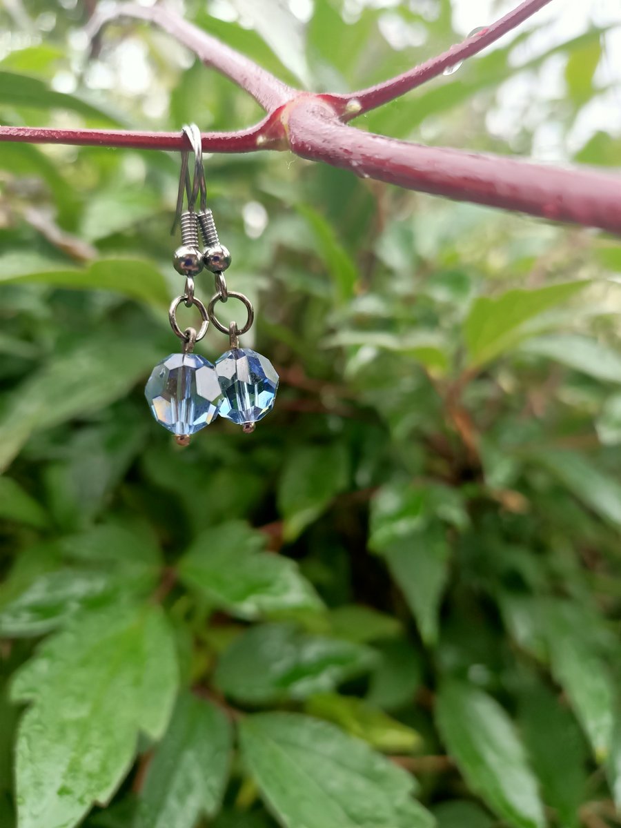 Blue sparkle crystal drop earrings on black ball hook earrings