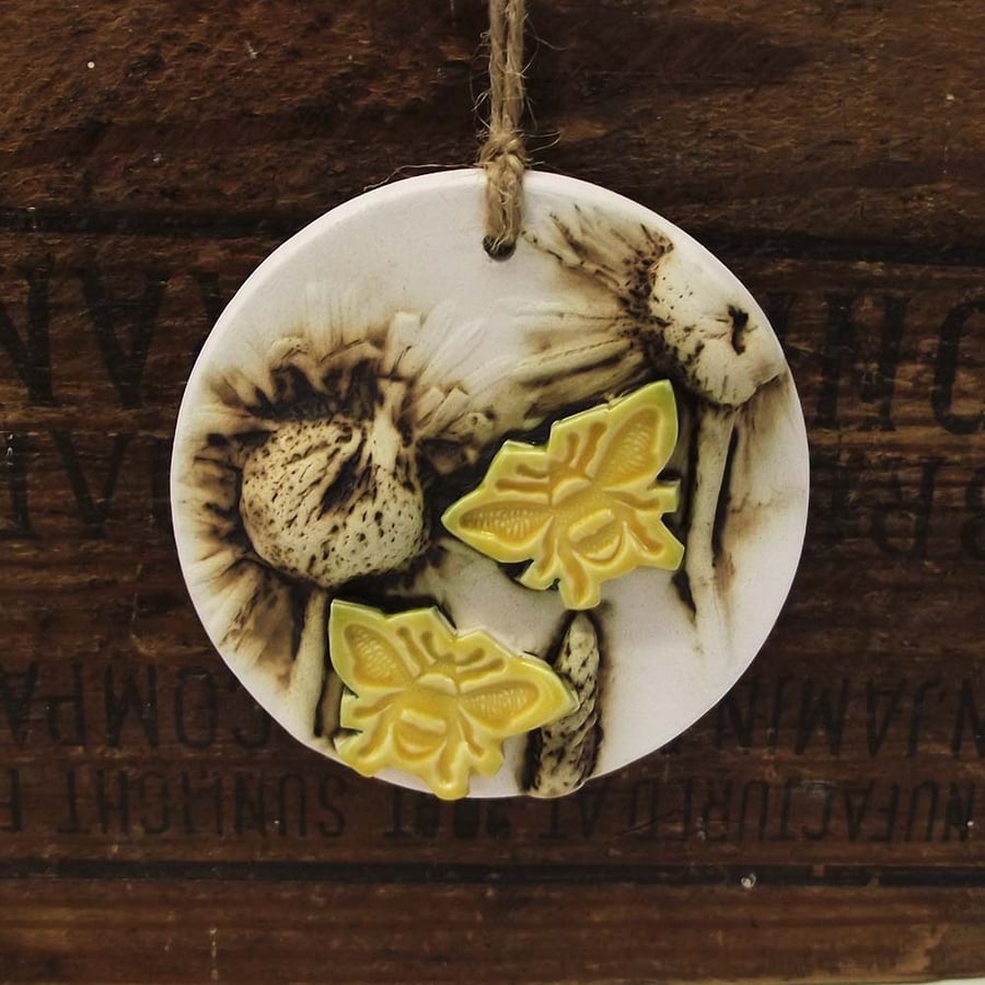 Pottery decoration with natural flower and bee motif.