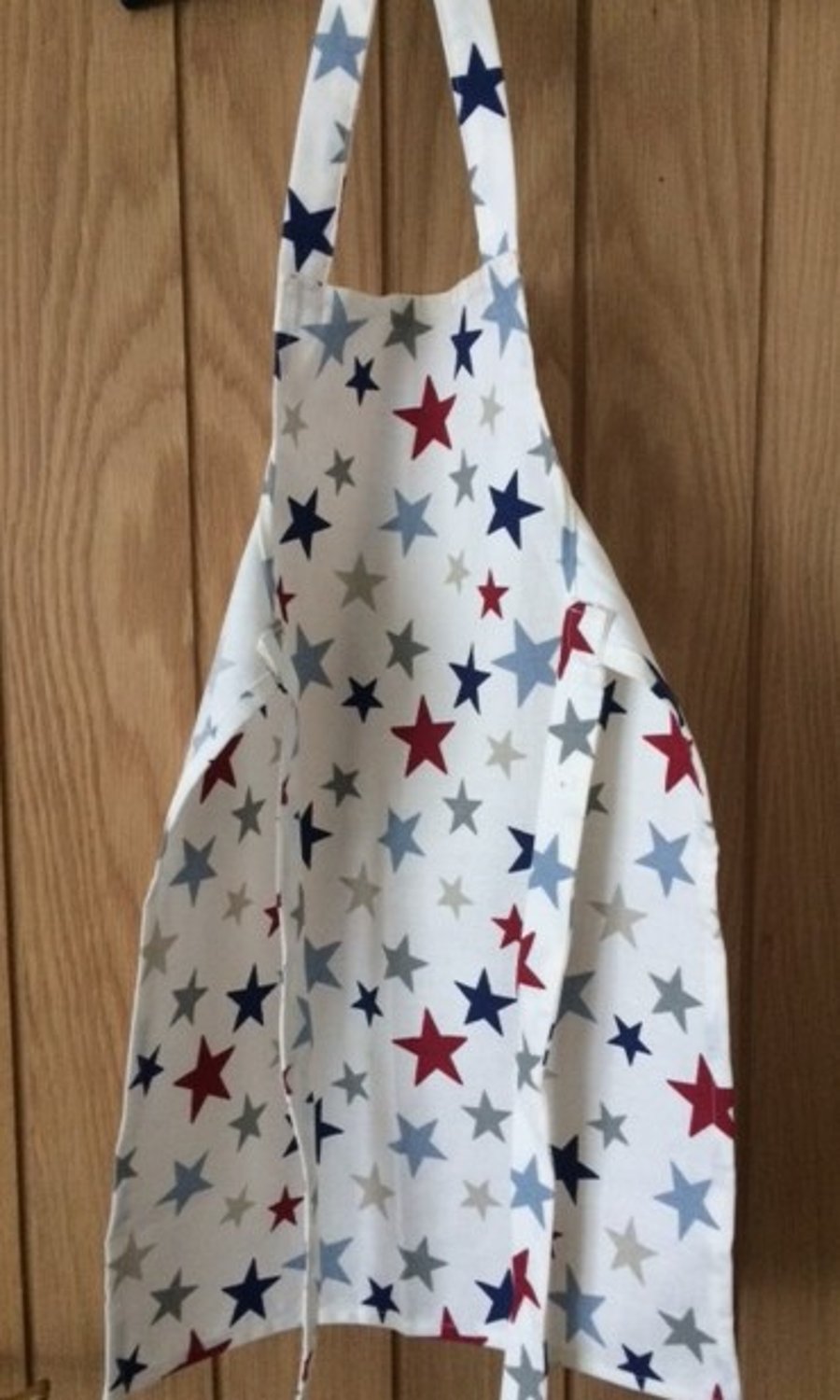 Children's cotton apron in a multi-coloured star pattern