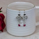 Silver heart dangly earrings with red rubies