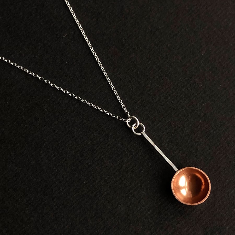 Sterling silver and copper spoon pendant.