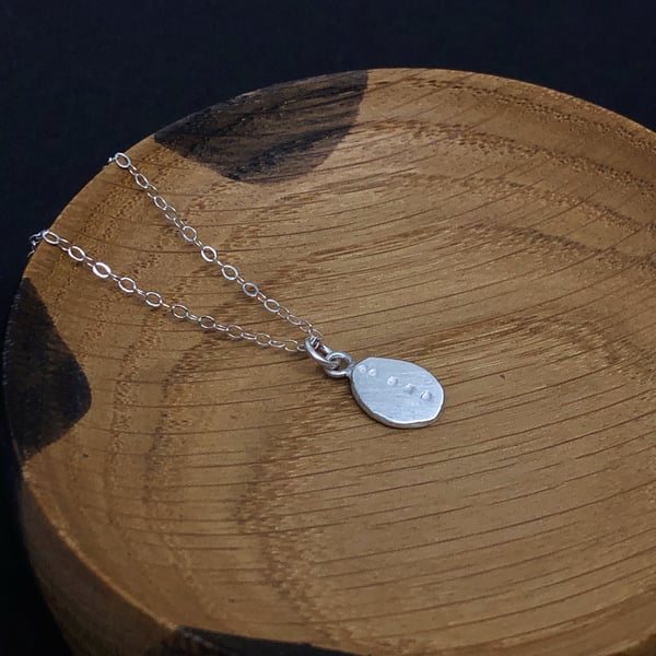 Recycled silver pendant with hand punched detail.