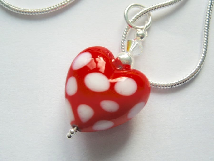 Red and white polka dot Murano glass heart pendant with sterling silver.